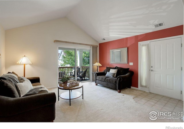 living room with light tile patterned floors and vaulted ceiling