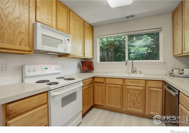 kitchen featuring sink and white appliances