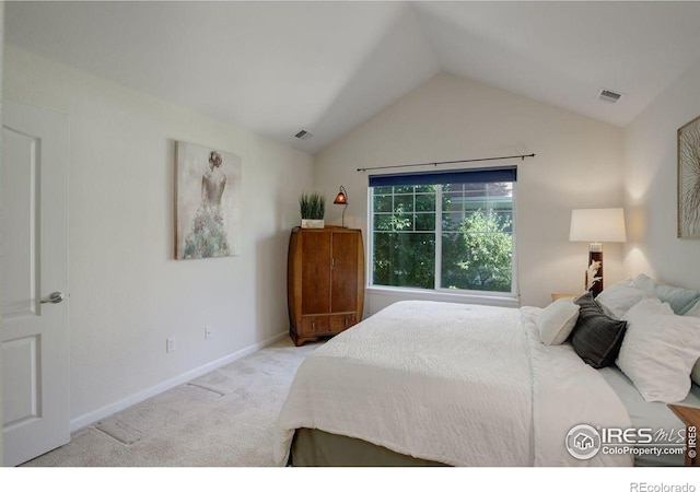 bedroom featuring light carpet and lofted ceiling