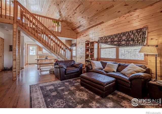 living room featuring wood walls, hardwood / wood-style floors, high vaulted ceiling, and wooden ceiling