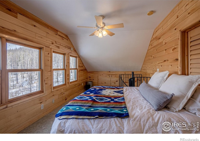 carpeted bedroom with wooden walls, ceiling fan, and lofted ceiling