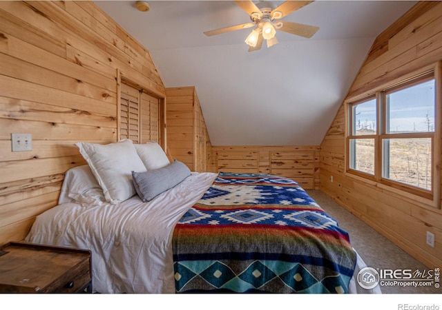 carpeted bedroom with wooden walls, ceiling fan, and lofted ceiling