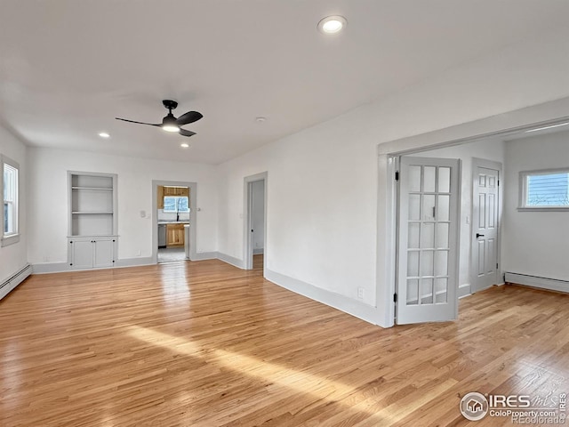 unfurnished living room with ceiling fan, built in features, light hardwood / wood-style floors, and a baseboard heating unit