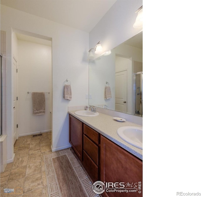 bathroom with vanity and an enclosed shower