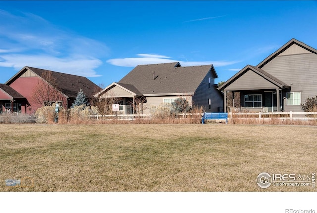 rear view of house with a lawn