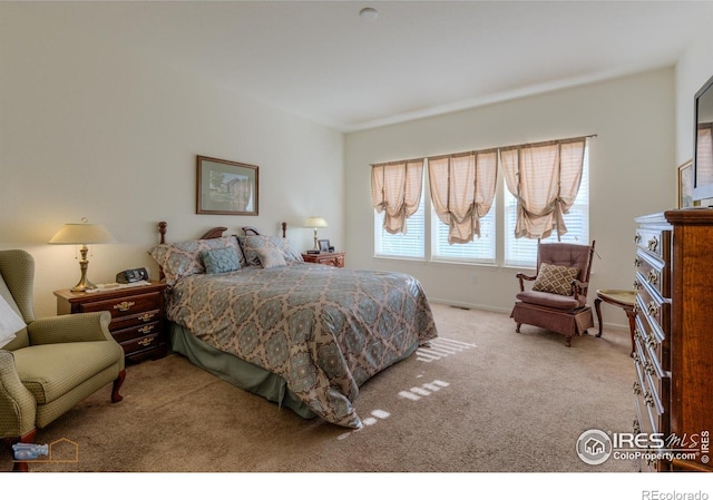 carpeted bedroom with baseboards
