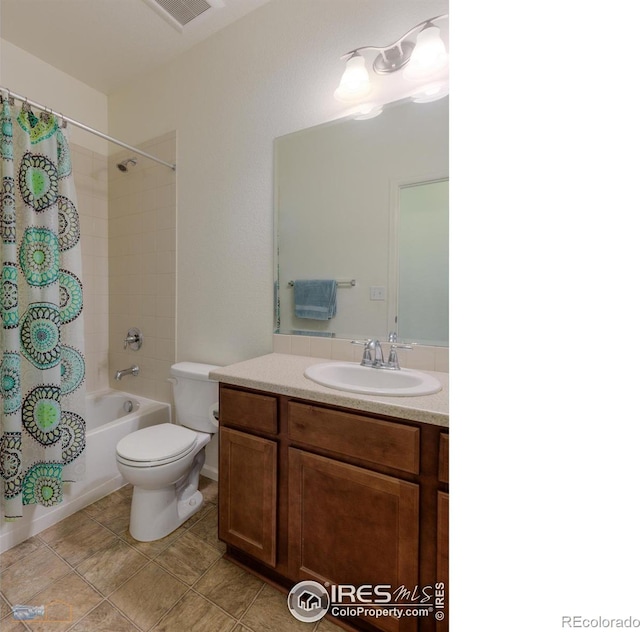 full bath with visible vents, toilet, vanity, and shower / tub combo