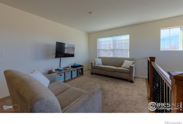 living area featuring baseboards and carpet floors