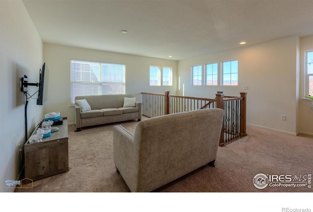 living room with recessed lighting, carpet floors, and baseboards