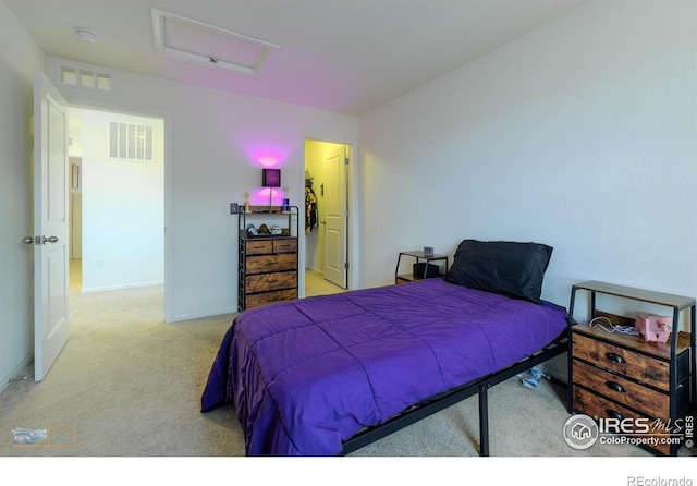 carpeted bedroom with attic access, baseboards, and visible vents
