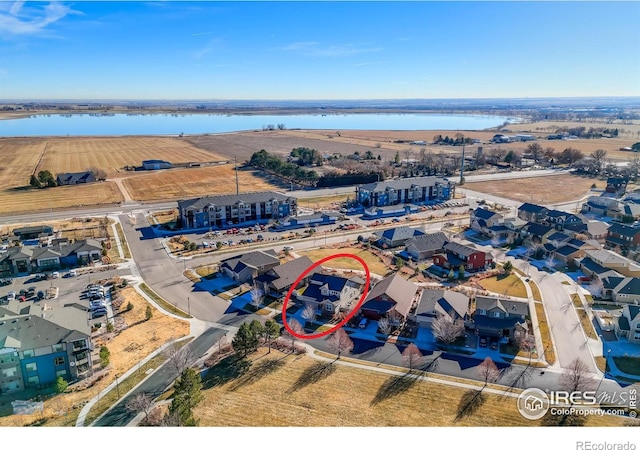 birds eye view of property featuring a water view and a residential view