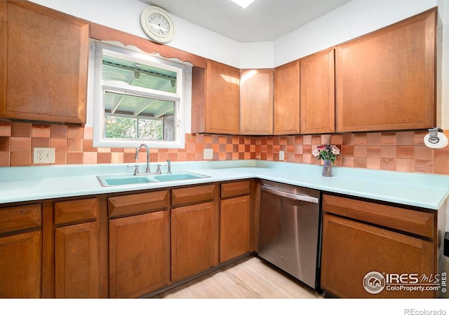 kitchen with light hardwood / wood-style floors, sink, backsplash, and dishwasher