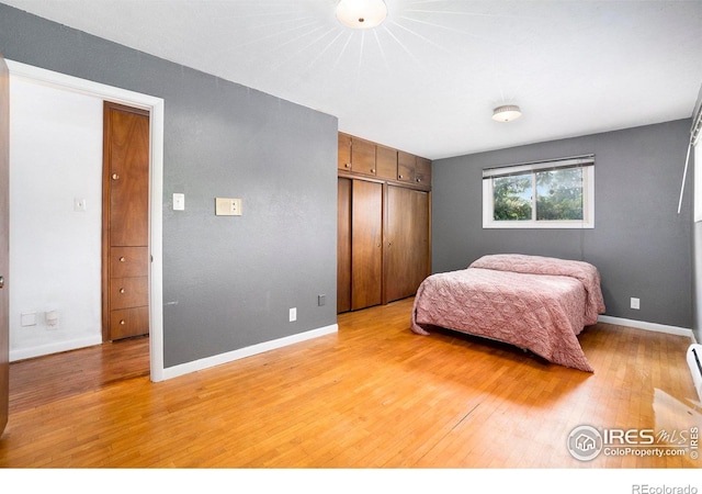 bedroom featuring light hardwood / wood-style floors and a closet