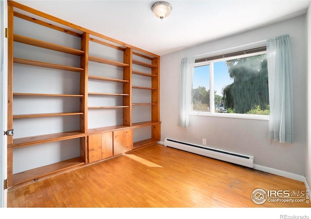 interior space featuring wood-type flooring and a baseboard radiator