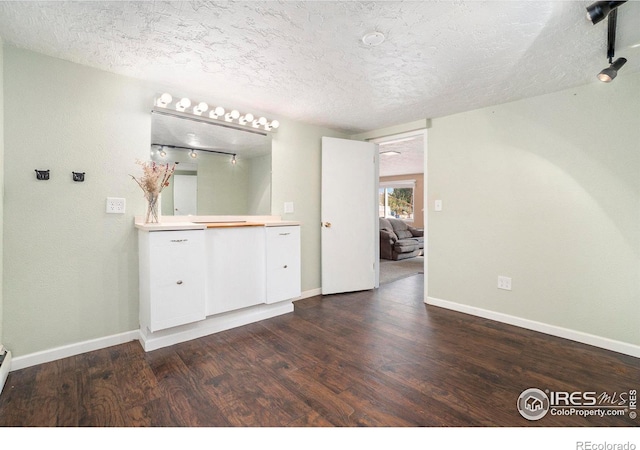 bathroom with a textured ceiling and hardwood / wood-style floors