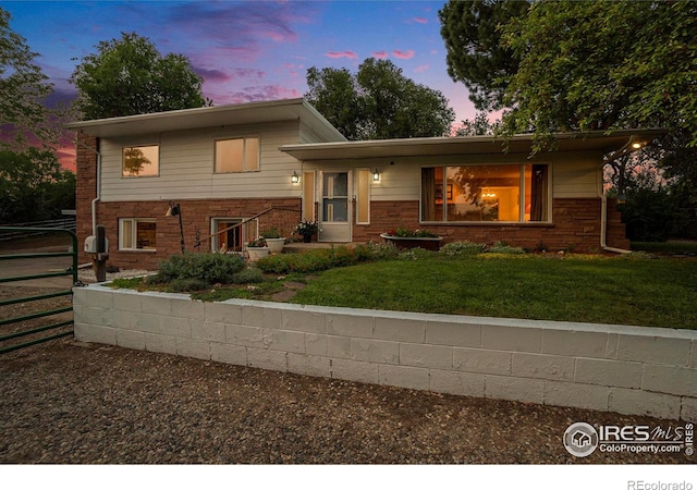 split level home with a lawn