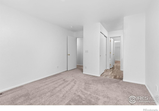 unfurnished bedroom with carpet and baseboards