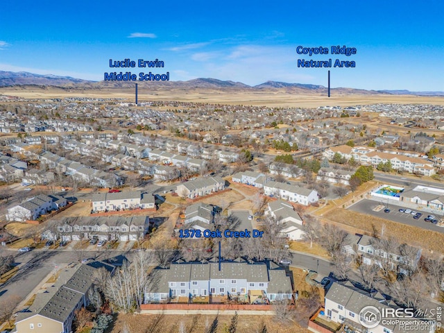 birds eye view of property with a residential view and a mountain view