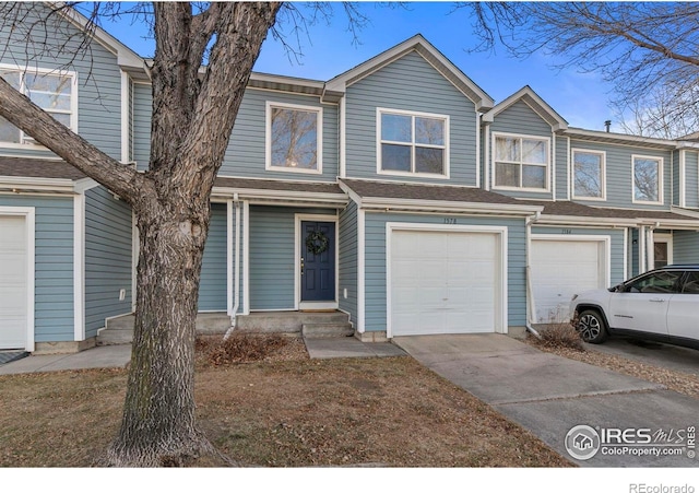 townhome / multi-family property featuring a garage and concrete driveway