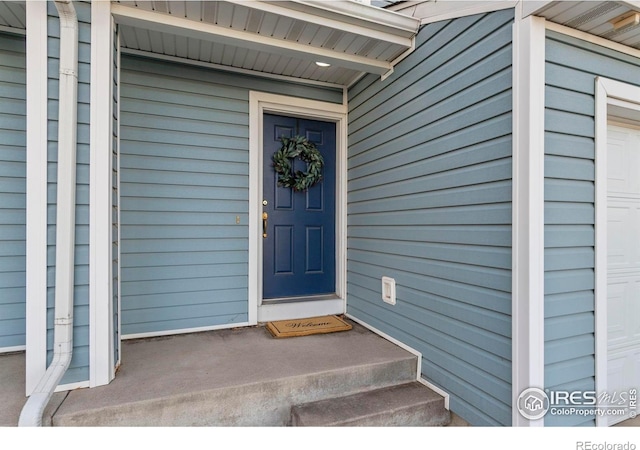 view of exterior entry with a garage