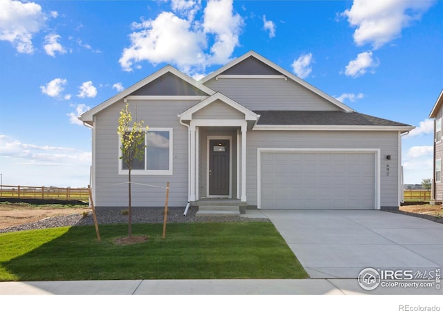 view of front of property with a front yard and a garage