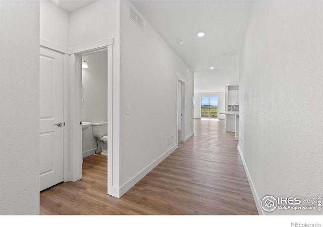 corridor featuring light hardwood / wood-style flooring