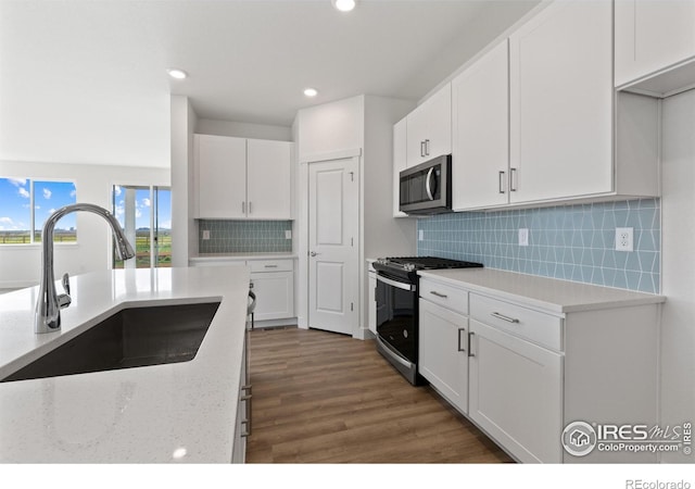 kitchen featuring sink, white cabinets, and appliances with stainless steel finishes