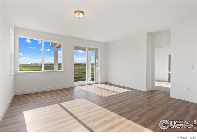 spare room featuring hardwood / wood-style floors