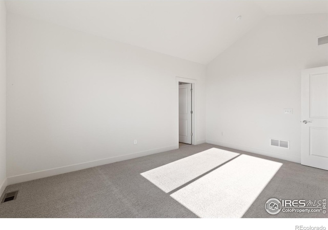 unfurnished bedroom with carpet flooring and high vaulted ceiling