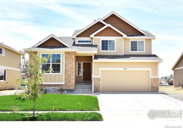 craftsman-style house with a garage and a front lawn