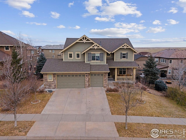 craftsman house with a garage and a front yard