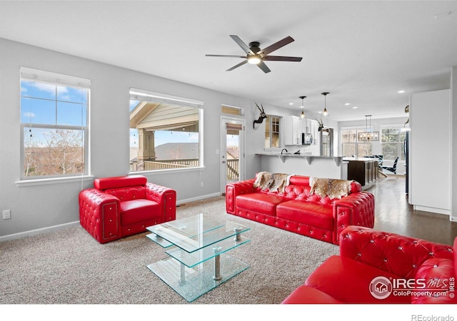 living room with carpet and ceiling fan