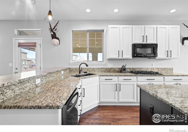 kitchen featuring light stone counters, white cabinets, sink, and black appliances