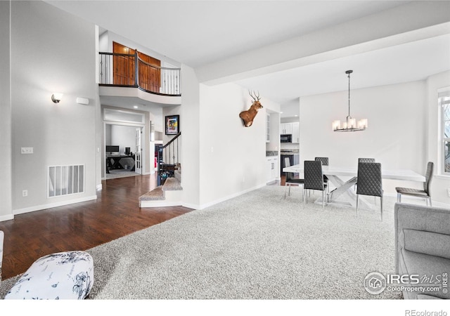 living room with wood-type flooring and a chandelier