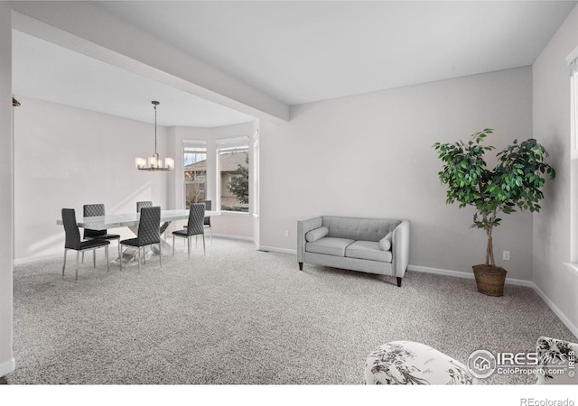 sitting room with a notable chandelier and carpet