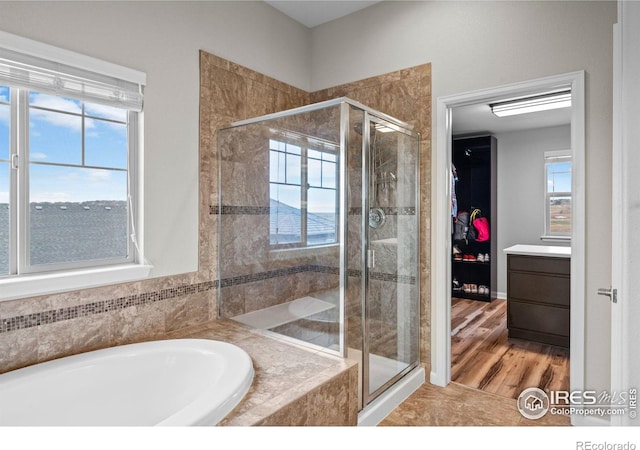 bathroom with independent shower and bath and vanity