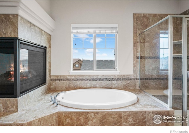 bathroom featuring separate shower and tub