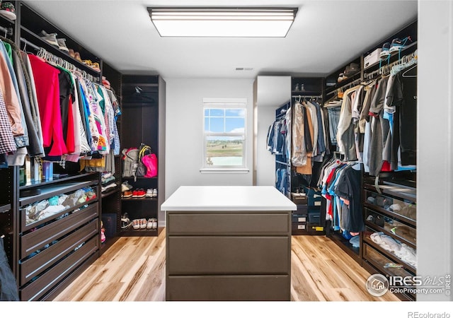 spacious closet featuring light hardwood / wood-style flooring