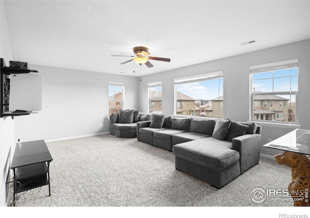 carpeted living room with ceiling fan