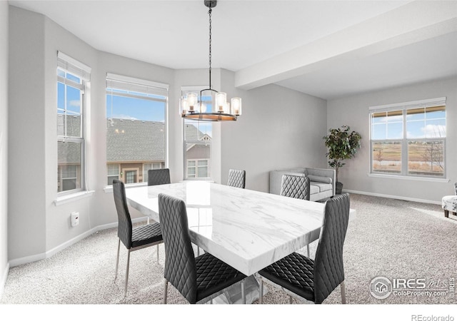 carpeted dining area with beam ceiling and a chandelier