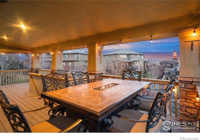 dining space with hardwood / wood-style floors and ornate columns