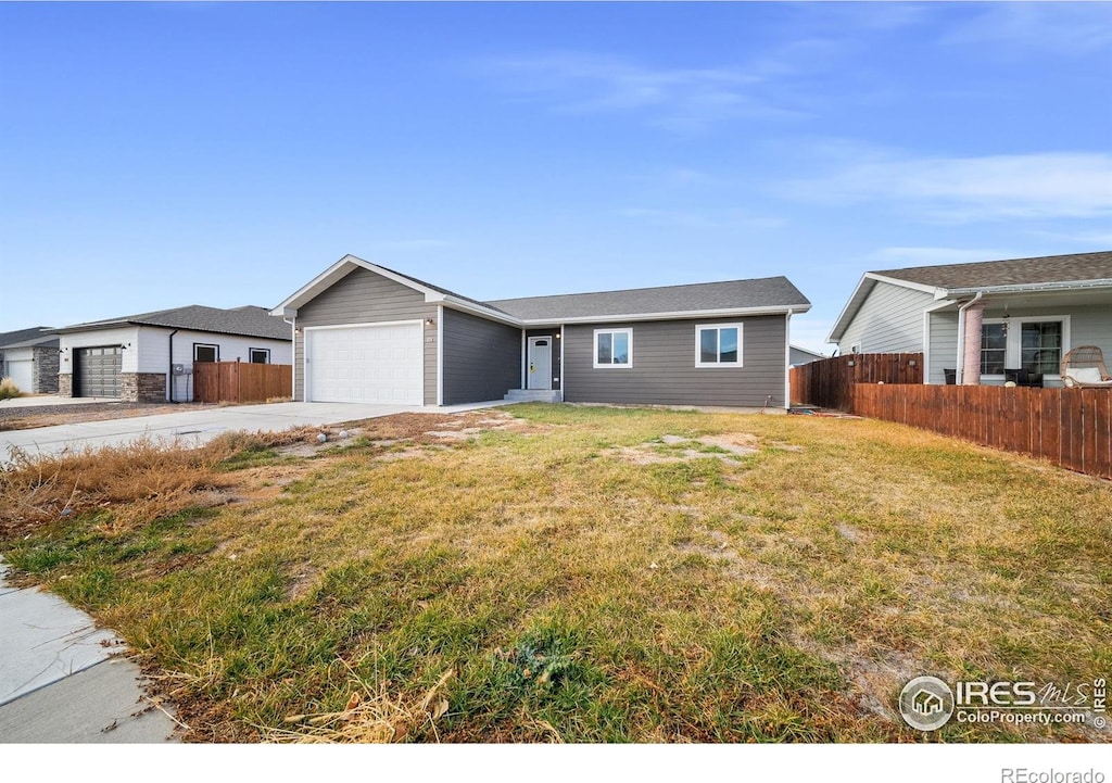 ranch-style house with a front yard and a garage