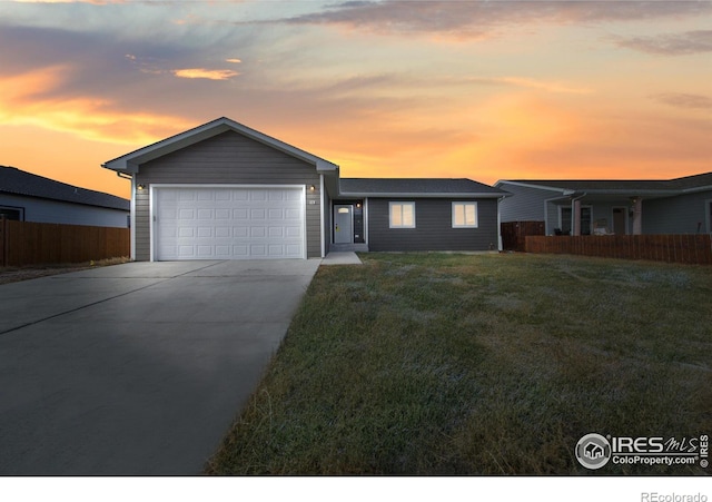 ranch-style home with a lawn and a garage