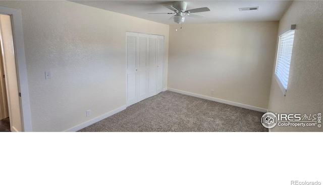 unfurnished bedroom featuring ceiling fan, a closet, and carpet