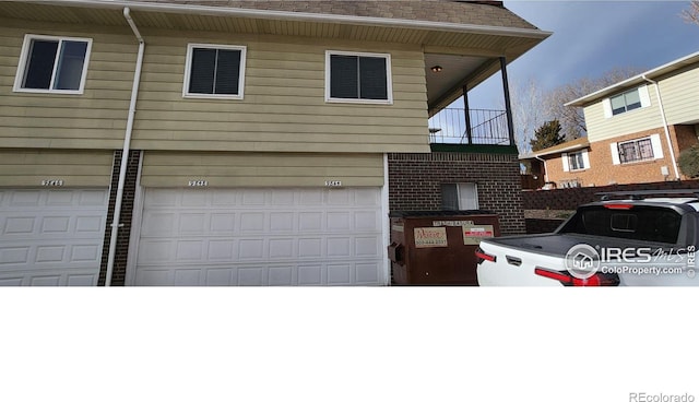 view of front of property with a balcony and a garage