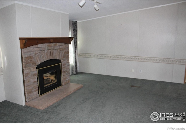 unfurnished living room with carpet flooring, a stone fireplace, and ornamental molding