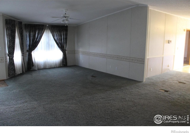 spare room featuring carpet flooring and ceiling fan