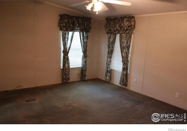 carpeted empty room with ceiling fan and ornamental molding