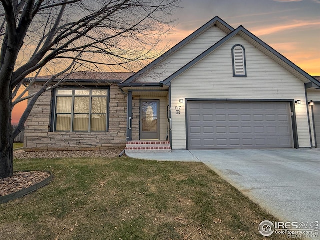 single story home with a lawn and a garage