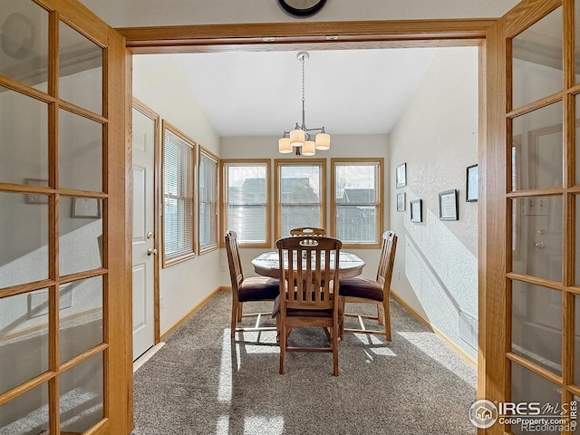 dining room with french doors, an inviting chandelier, and lofted ceiling